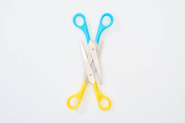 top view of colourful scissors isolated on white clipart