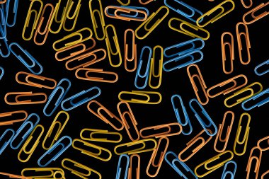 top view of colorful scattered paper clips isolated on black  clipart
