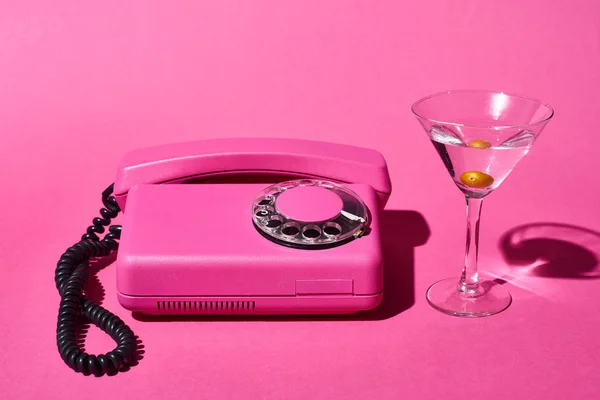 Transparent Glass Cocktail Olive Vintage Dial Phone Pink Background — Stock Photo, Image