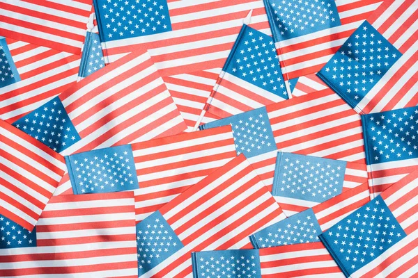 background of shiny national american flags in stack