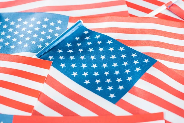 close up view of shiny national american flags in stack