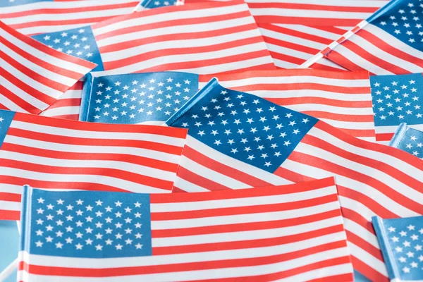 close up view of national colorful american flags in pile