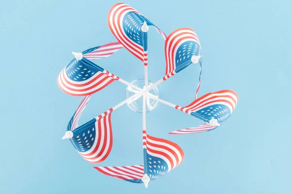 top view of american flags in circle on blue background