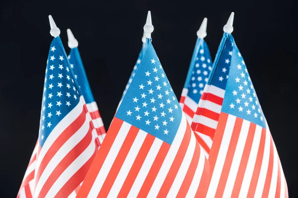 close up view of national american flags isolated on black
