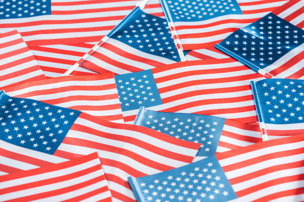 close up view of national usa flags in pile 