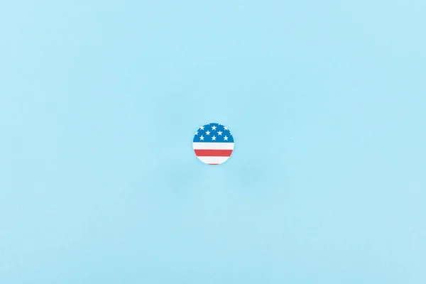 top view of paper cut decorative circle made of american flag on blue background 