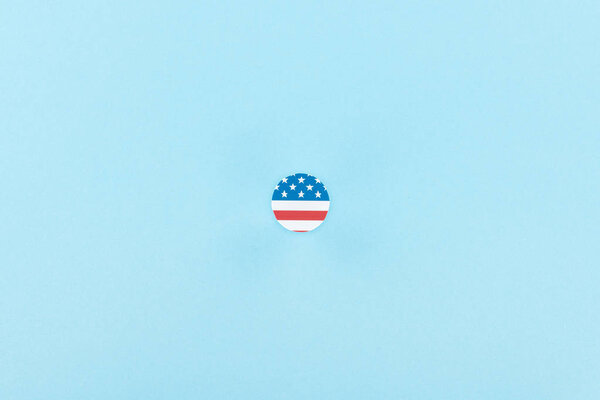 top view of paper cut decorative circle made of american flag on blue background 