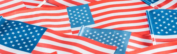close up view of colorful american flags in pile, panoramic shot