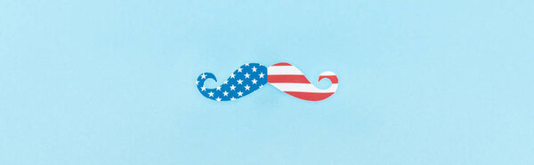 top view of mustache made of american flag on blue background, panoramic shot 