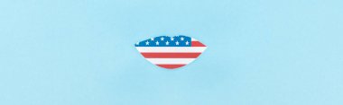 panoramic shot of paper cut lips made of american flag on blue background  clipart