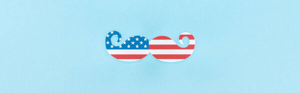 top view of decorative mustache made of american flag on blue background, panoramic shot 