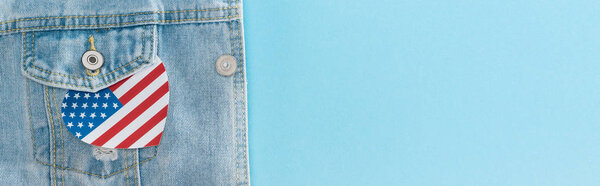 panoramic shot of paper cut heart made of american flag on denim stylish jacket on blue background 