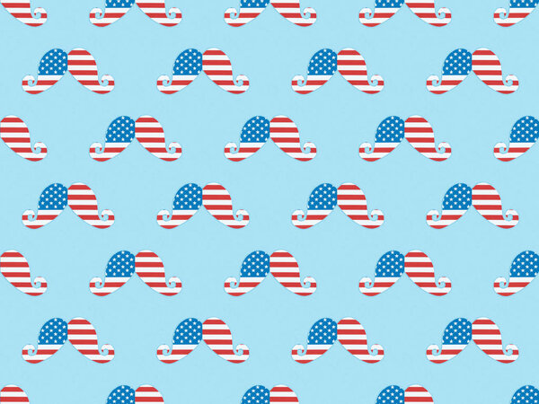 seamless background pattern with paper cut mustache made of usa flags on blue 