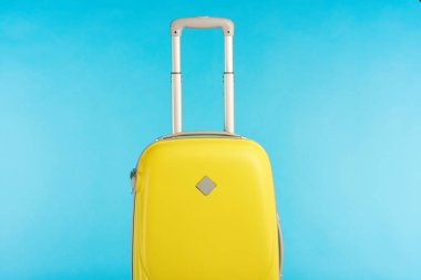 yellow colorful travel bag with handle isolated on blue clipart