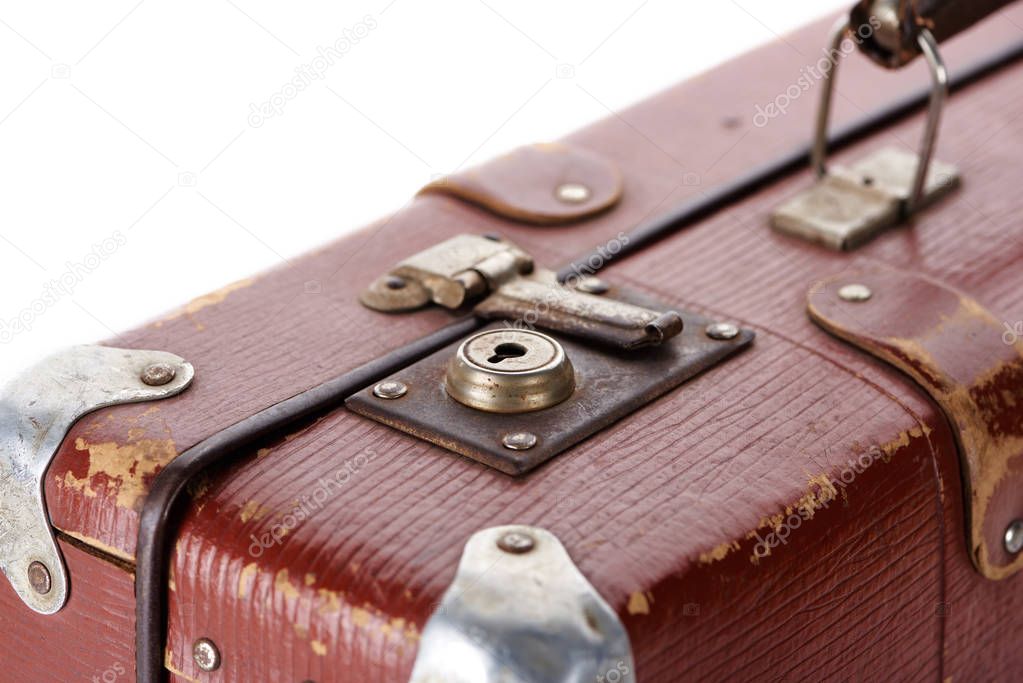 close up view of metal rusty lock on vintage brown suitcase isolated on white