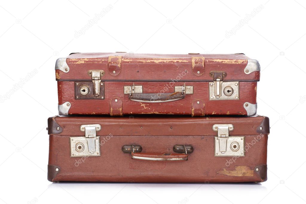 two vintage brown leather suitcases isolated on white