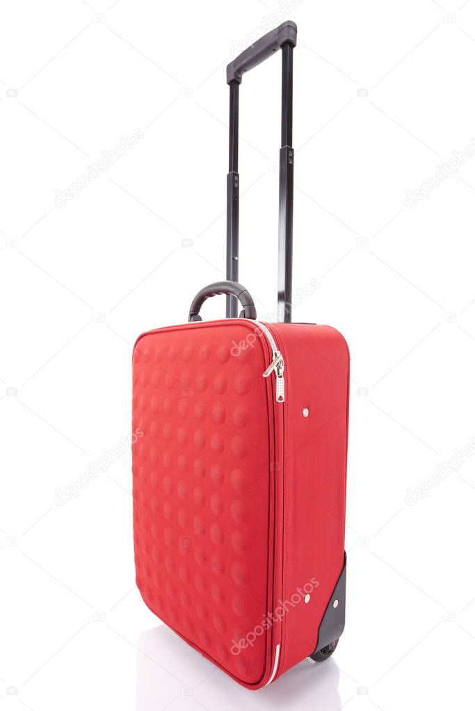 red wheeled textured colorful suitcase with handle isolated on white