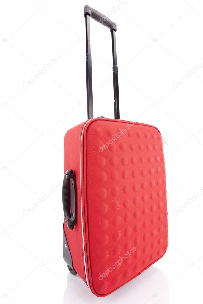 red wheeled textured suitcase with handle isolated on white