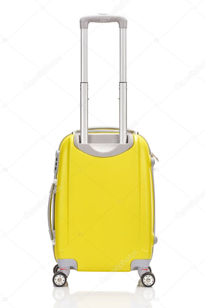 back view of yellow plastic wheeled colorful suitcase with handle isolated on white