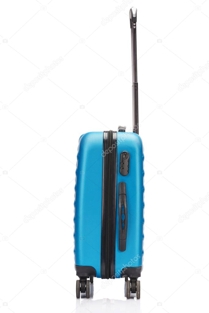 side view of blue wheeled colorful suitcase with handle isolated on white