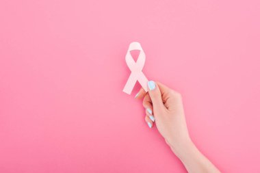 partial view of woman with pink breast cancer sign on pink background clipart