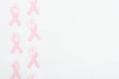 top view of silk pink breast cancer signs on white background with copy space clipart