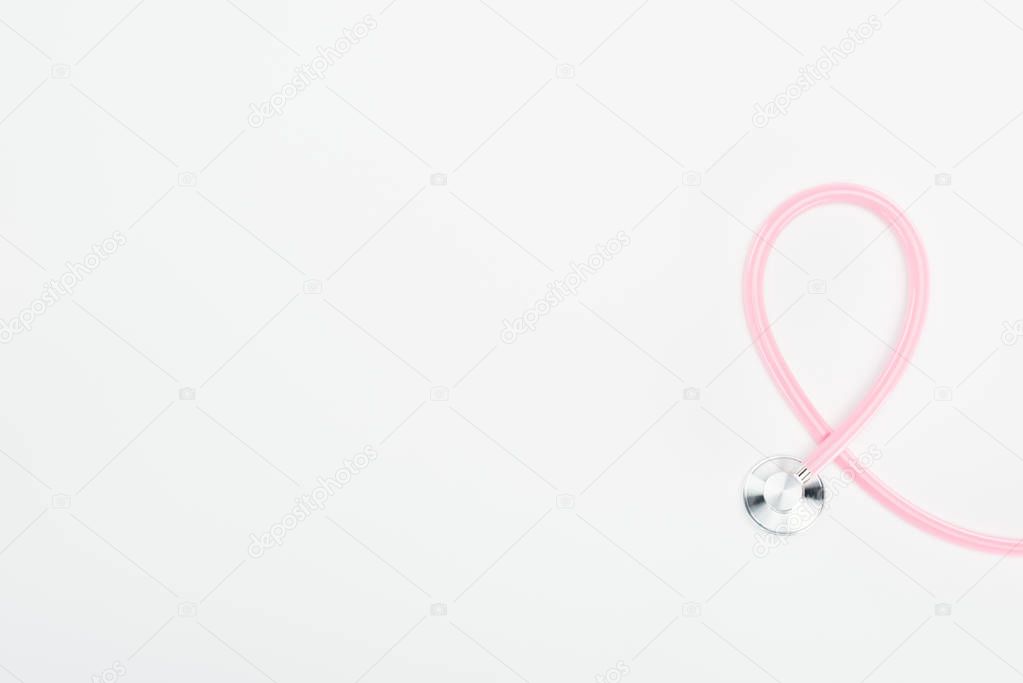 top view of stethoscope on white background with copy space, breast cancer concept