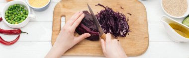 cropped view of woman cutting red cabbage on wooden chopping board, panoramic shot clipart