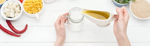 Cropped View Woman Adding Oil Empty Glass Jar Wooden White — Stock Photo, Image