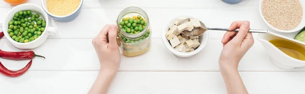 Cropped View Woman Adding Tofu Cheese Jar Salad Wooden White — Stock Photo, Image