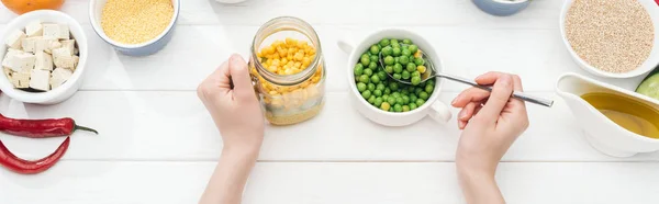 Cropped View Woman Adding Green Peas Jar Salad Wooden White — Stock Photo, Image