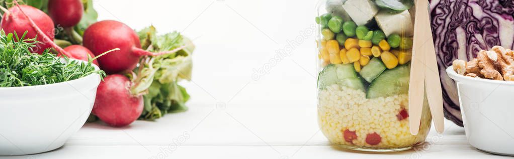 Fresh vegetable salad in glass jar near radish, red cabbage and nuts isolated on white, panoramic shot — Stock Image Fresh Vegetable Salad Glass Jar Radish Red Cabbage Nuts Isolated Royalty Free Stock Images