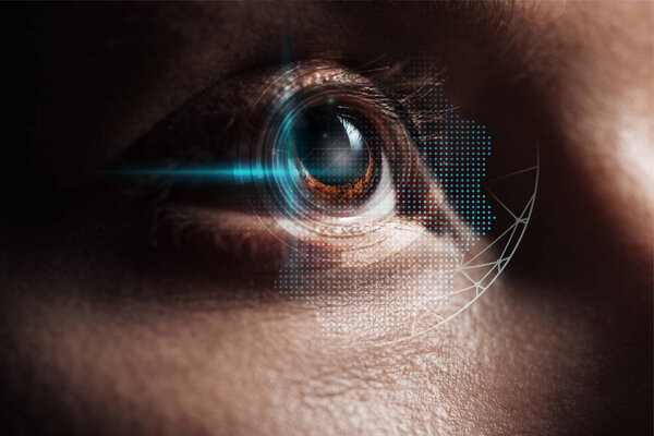 close up view of human eye in darkness with data illustration, robotic concept