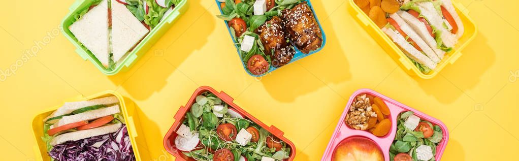 Panoramic shot of lunch boxes with food on yellow background — Stock Image Panoramic Shot Lunch Boxes Food Yellow Background Royalty Free Stock Photos