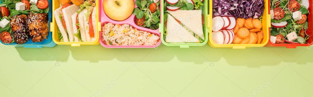 Panoramic shot of lunch boxes with food on green background — Stock Image Panoramic Shot Lunch Boxes Food Green Background Royalty Free Stock Photos