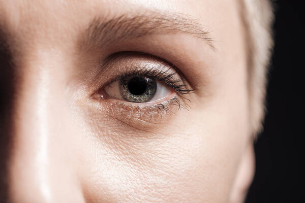 close up view of young woman grey eye looking at camera