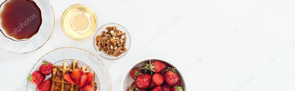 panoramic shot of breakfast with strawberries and waffle on white