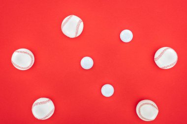 top view of white and leather softballs isolated on red  clipart
