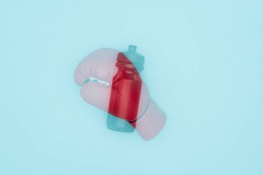 double exposure of red boxing glove and sport bottle isolated on blue  clipart