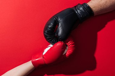 cropped view of man and woman in boxing gloves on red  clipart
