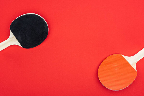 top view of ping pong rackets isolated on red 