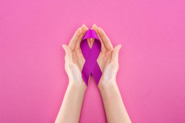 cropped view of woman holding purple ribbon means violence isolated on pink clipart