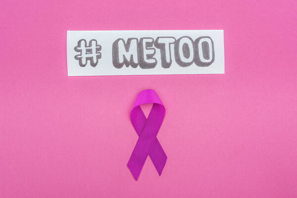 top view of domestic violence purple awareness ribbon near paper with hashtag me too isolated on pink