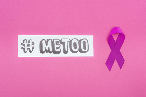 top view of purple awareness ribbon near hashtag me too on paper isolated on pink