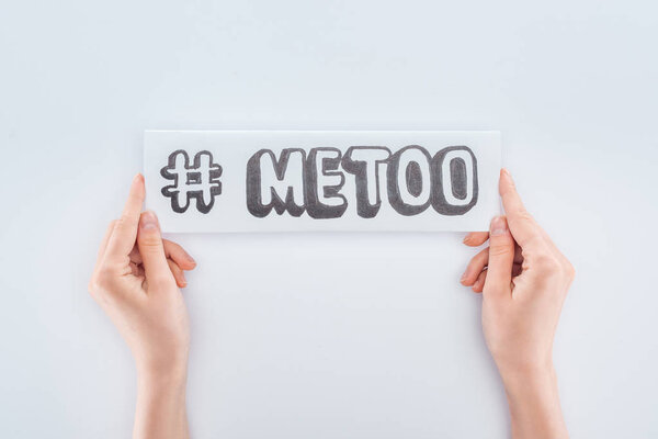 cropped view of woman holding paper with hashtag me too isolated on white