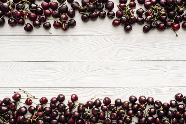 top view of fresh, sweet and washed cherries on wooden background 