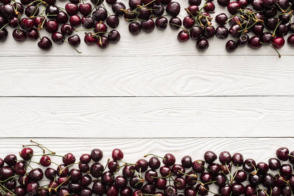 top view of fresh, sweet and washed cherries on wooden background 