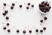 top view of sweet and whole cherries on bowl on white background 
