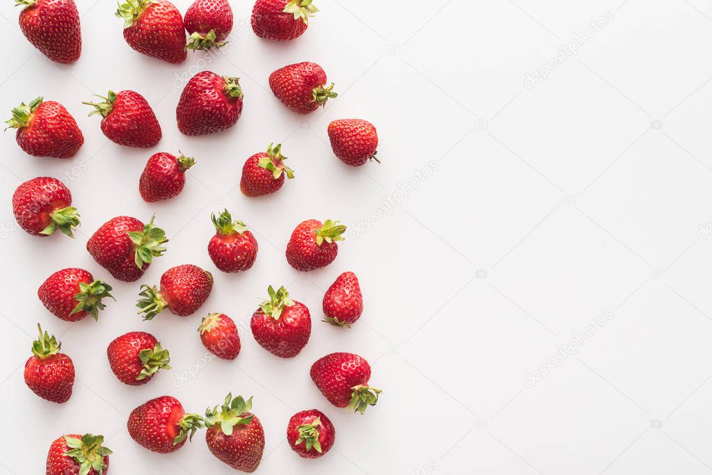 top view of sweet and red strawberries on white background with copy space 