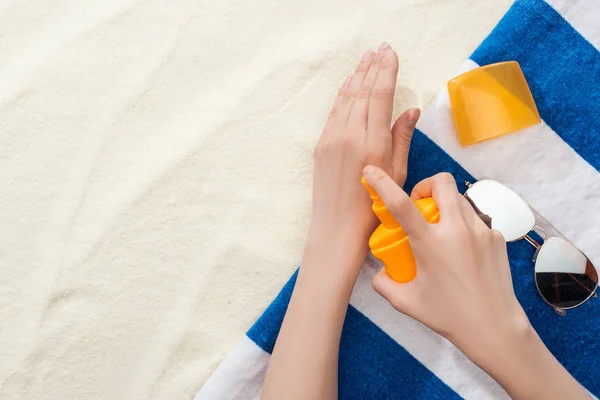 Cropped View Woman Applying Sunscreen Hands Striped Towel Sunglasses Sand — Stock Photo, Image